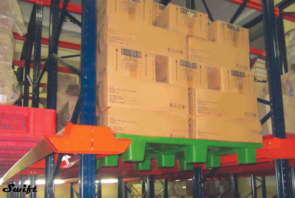 plastic pallets that are racked in pallet racks for storage.